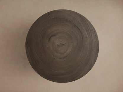 Toluca End Table with a smooth circular wooden top and rich brown grain detail, set against a neutral background.