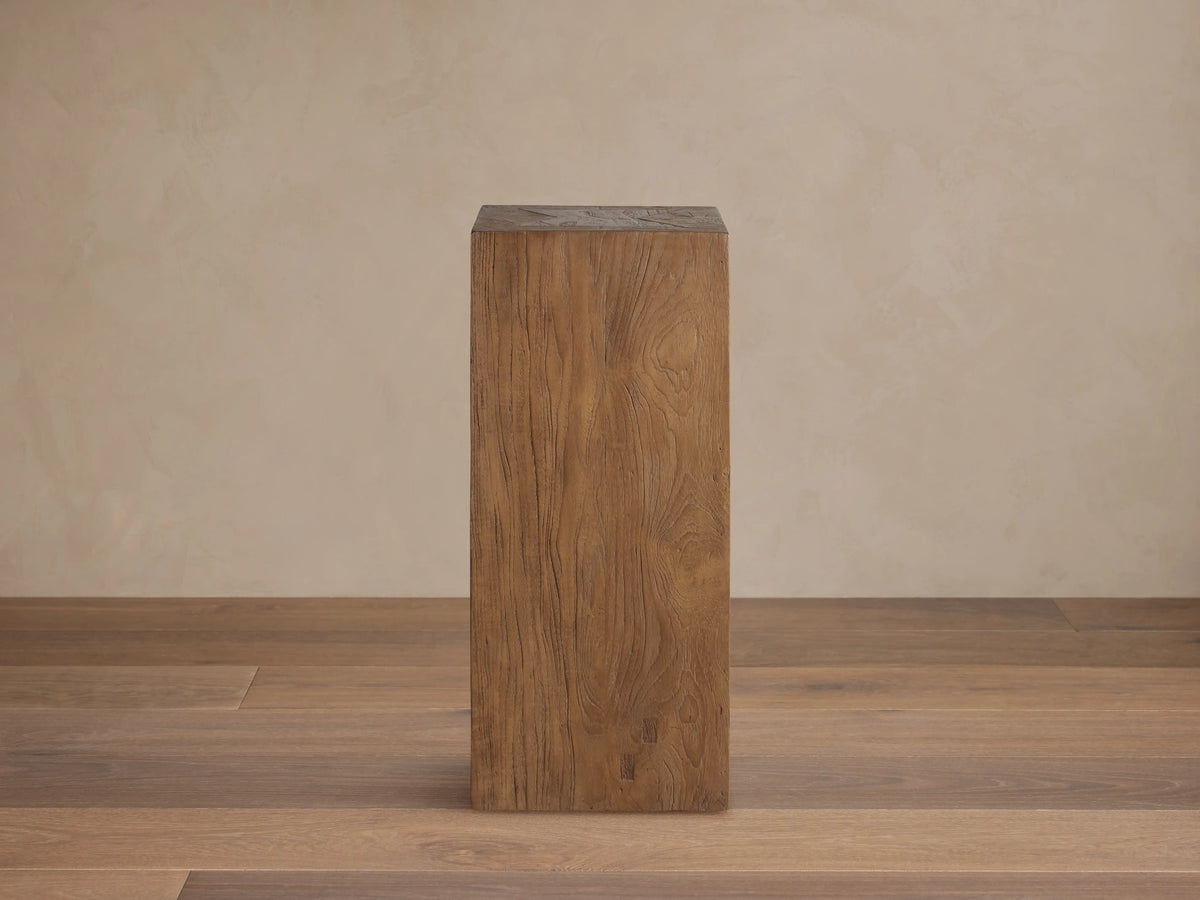 Tall rectangular Ubud Pedestal made of reclaimed teak wood in a warm brown finish. Displays organic textures and unique wood grain.