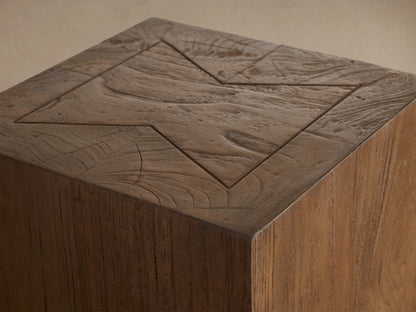 Ubud Pedestal made of reclaimed teak in a rectangular shape, featuring rich, natural brown tones and visible wood grain, on a wooden floor.