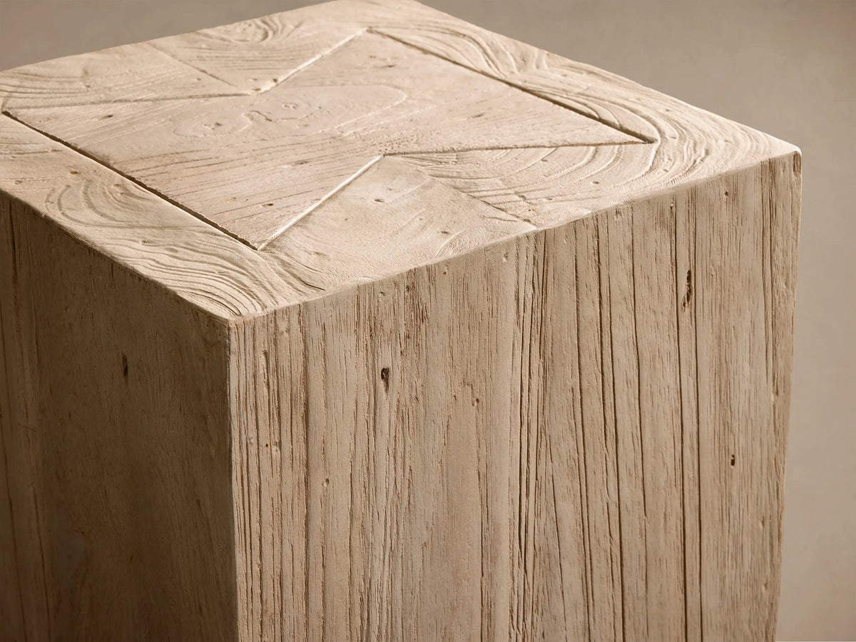Close-up of Driftwood Ubud Pedestal, showing its light beige reclaimed teak wood texture and carved geometric pattern on top.