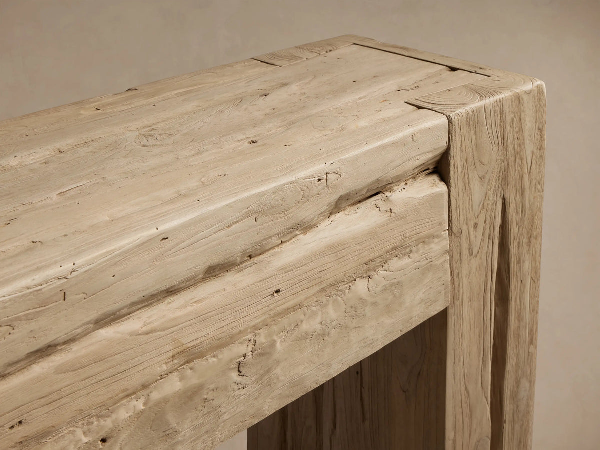 Close-up of the Driftwood finish Ubud Console Table, showing reclaimed teak wood with visible grain and rustic corner joint.