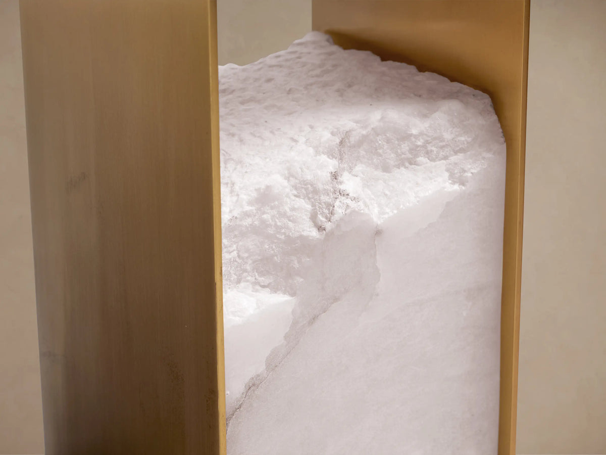 Detail of Urben Martini Table's base with a textured white alabaster block nestled between two vertical antique brass panels.