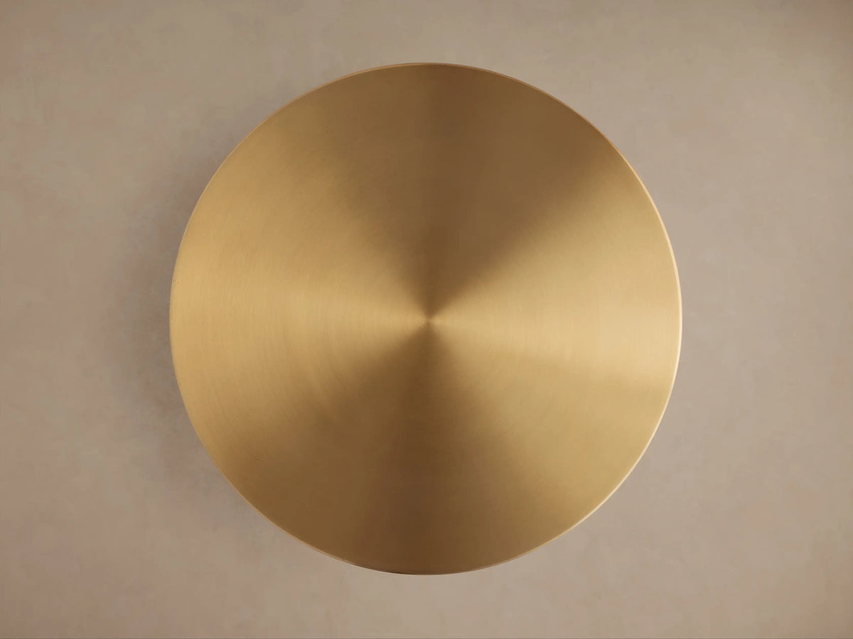 Close-up of the Urben Martini Tabletop, a circular brushed brass surface with a reflective gold sheen.