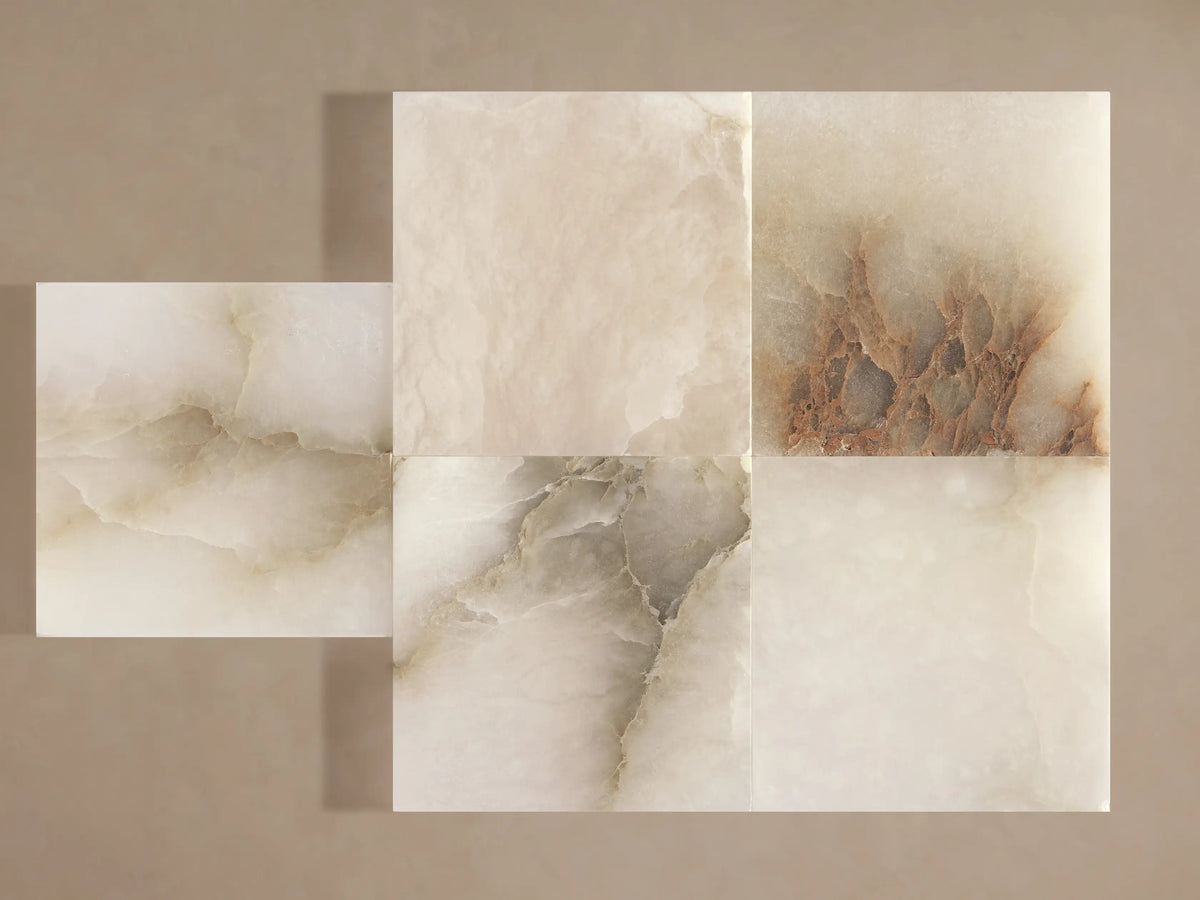 Close-up of square alabaster stone samples with natural beige, brown, and grey veining, material for Urben Martini Table.