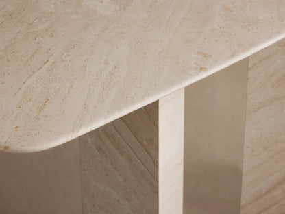 Vesuvius Console Table, light beige marble with natural veining, a rounded rectangular top, and two thick angular slab legs.