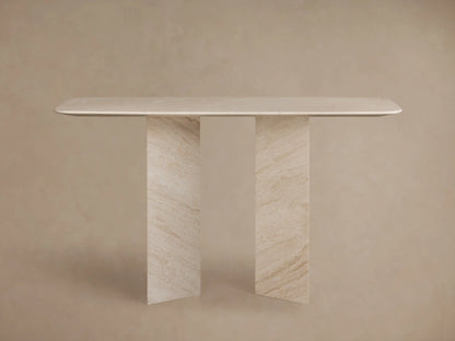 Close-up of Vesuvius Console Table. Light beige natural marble tabletop with rounded edge over angular legs, showing veining.