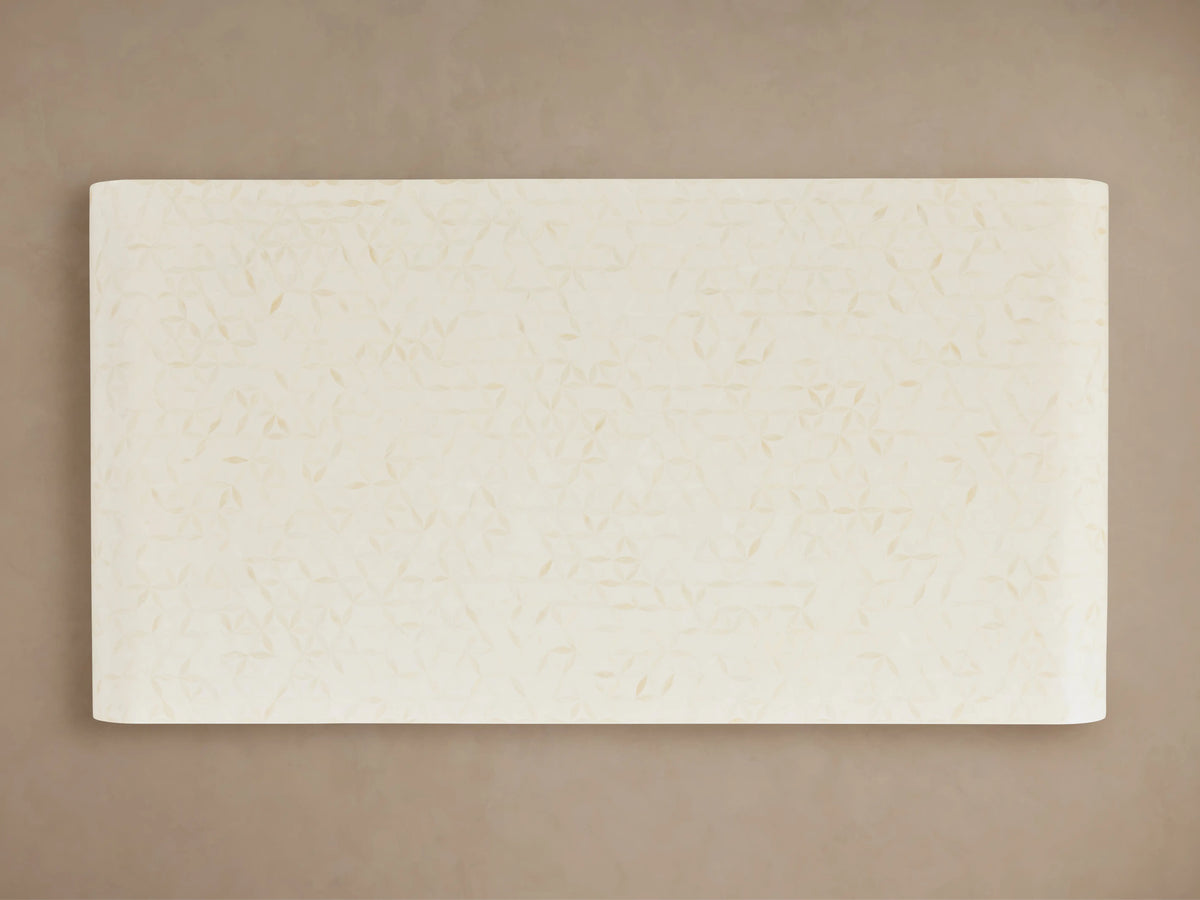 Visola Coffee Table with rectangular top view, ivory-colored surface, subtle geometric patterns, set on a neutral background.