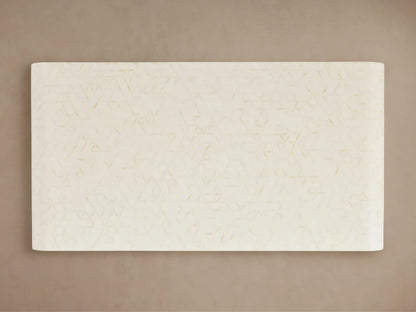 Visola Coffee Table with rectangular top view, ivory-colored surface, subtle geometric patterns, set on a neutral background.