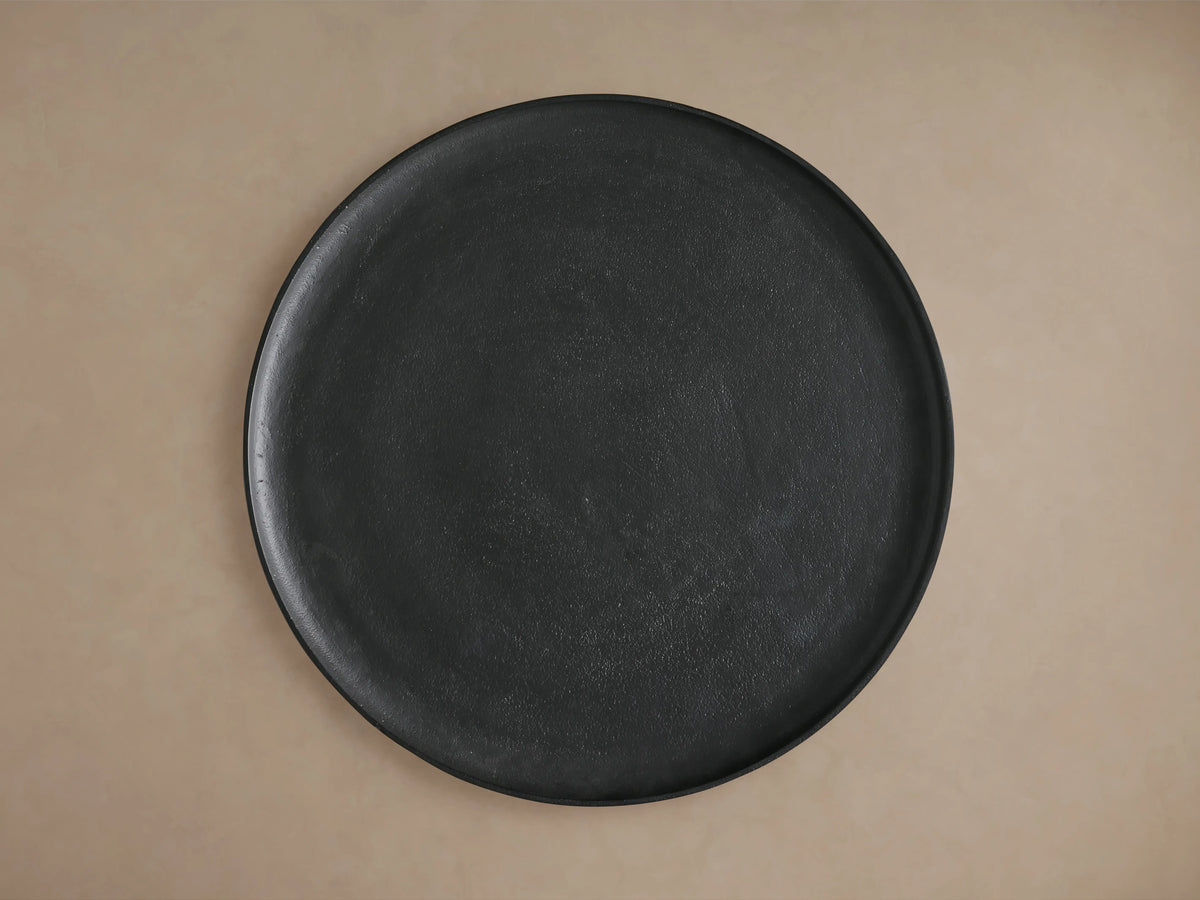 Round Zephyr Martini Table made of dark cast aluminum, featuring a smooth, slightly textured surface, shown from a top view against a neutral background.