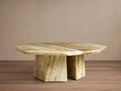 Front view of the green onyx Zyra Round Coffee Table, featuring an asymmetrical tabletop and split pedestal-style base.