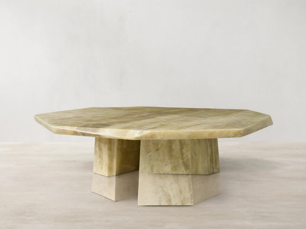 Front view of the green onyx Zyra Round Coffee Table, featuring an asymmetrical tabletop and split pedestal-style base.
