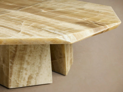 Front view of the green onyx Zyra Round Coffee Table, featuring an asymmetrical tabletop and split pedestal-style base.