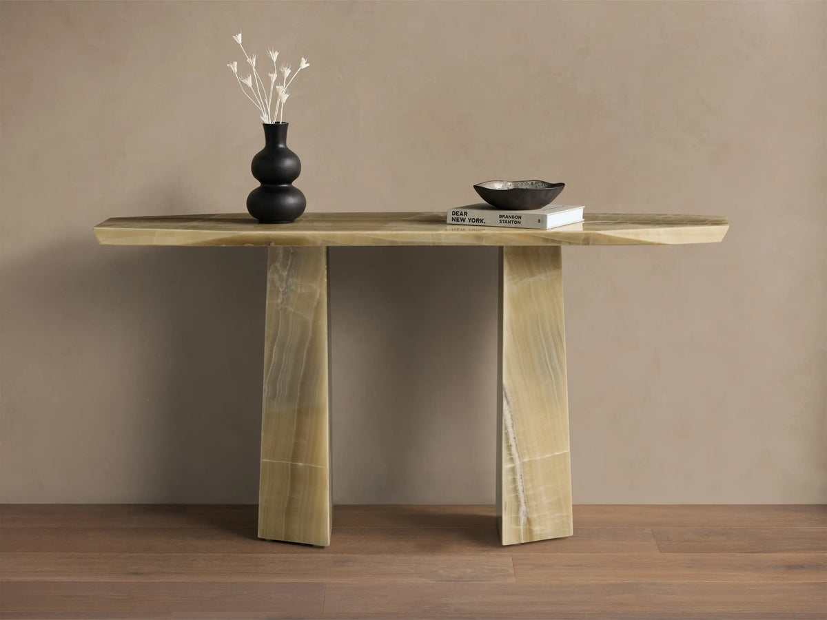 Front view of the green onyx Zyra Console Table, showcasing its asymmetrical top and two solid pedestal bases.