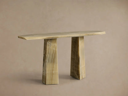 Front view of the green onyx Zyra Console Table. It features an asymmetrical top and two split pedestal bases with natural veining.