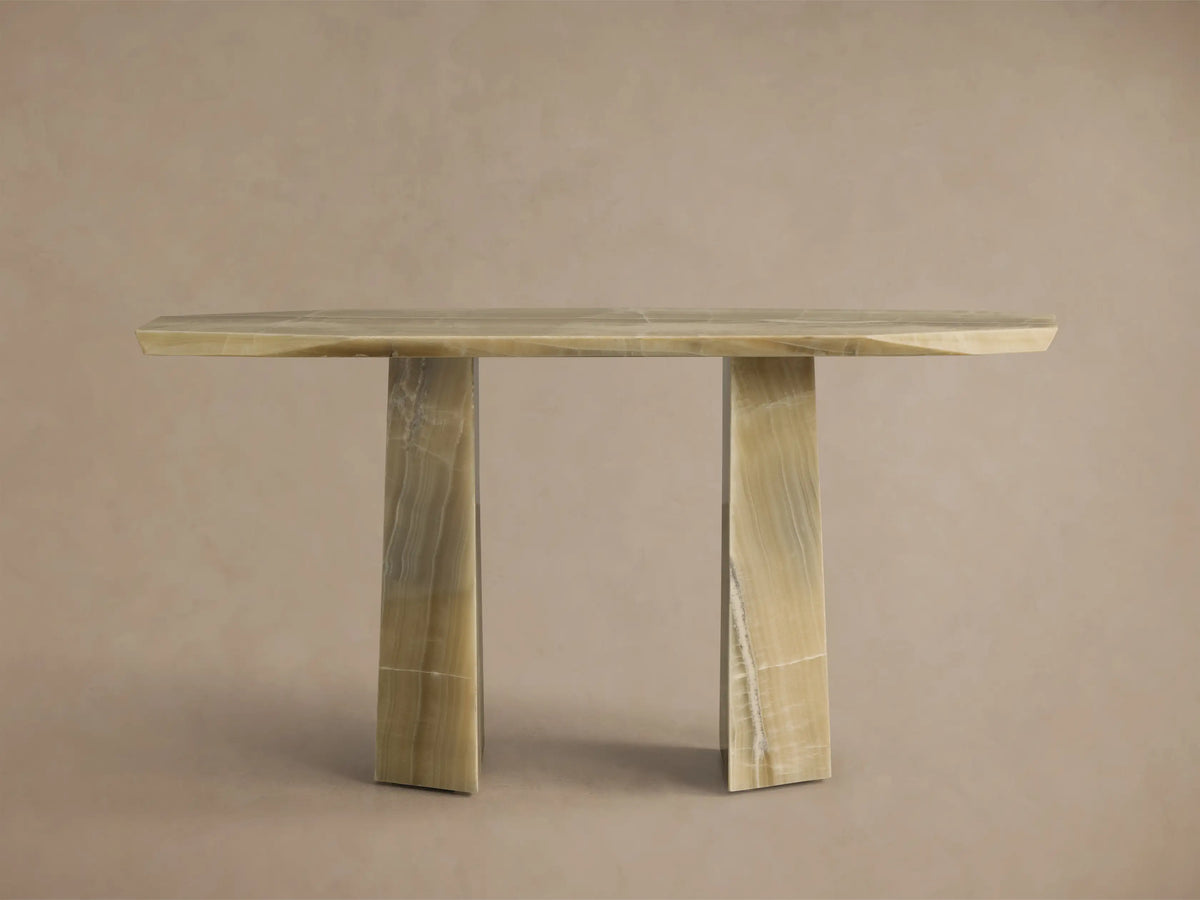 Front view of the light green onyx Zyra Console Table, featuring an asymmetrical top and two pedestal bases with natural striations.
