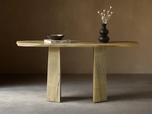 Front view of the green onyx Zyra Console Table, showcasing its asymmetrical top and two solid pedestal bases.