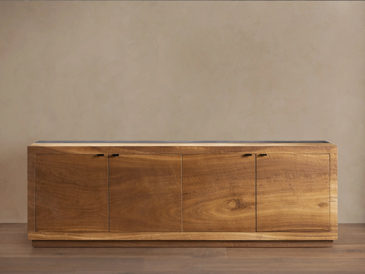 Acacius Media Console made from reclaimed yukas veneer features three warm-toned wooden cabinet doors, set against a neutral backdrop.