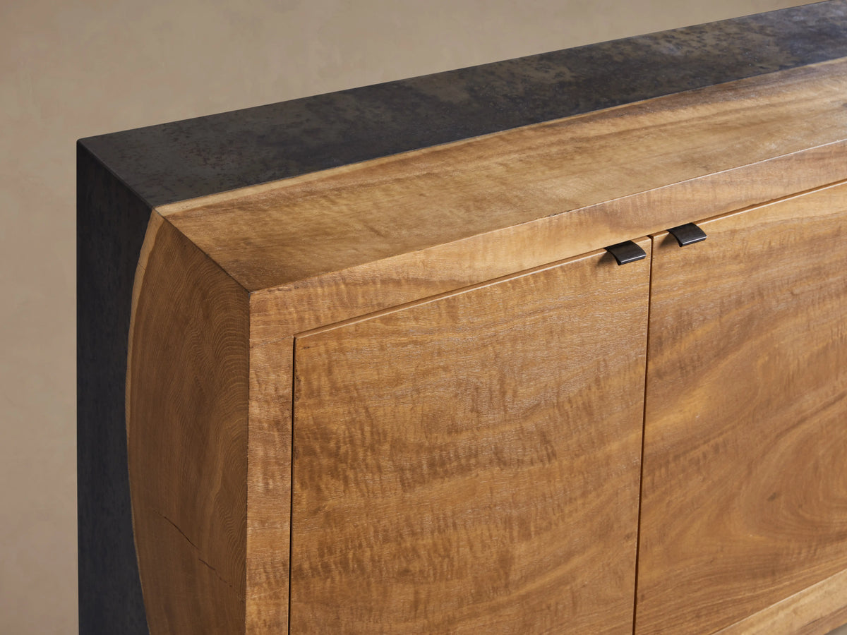 Acacius Media Console in light wood finish with three cabinet doors, metal hinges, and a sleek, rectangular design.