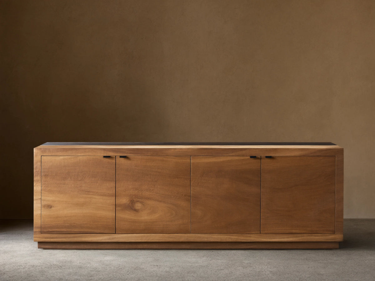 Acacius Media Console made from reclaimed yukas veneer features three warm-toned wooden cabinet doors, set against a neutral backdrop.
