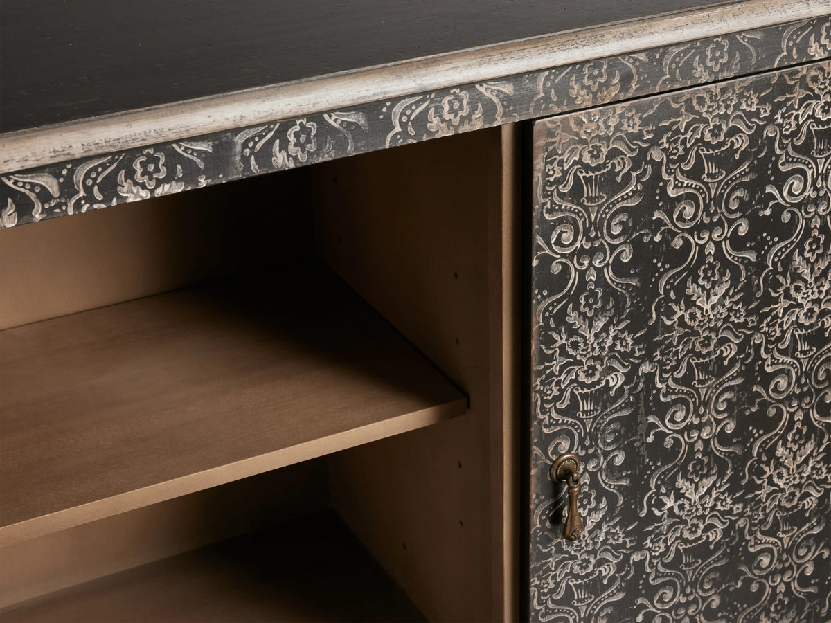Antique black Amalfi Cabinet with intricate white floral patterns on the door, open shelves inside, and a distressed finish.