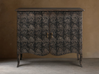 Amalfi Cabinet with intricate, hand-carved floral patterns on antique-finished wood, features two doors and curved legs.