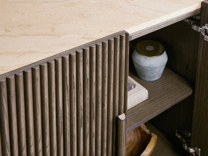 Astor Sideboard with curved, reeded oak veneer front & light marble top. One door open reveals two interior shelves.