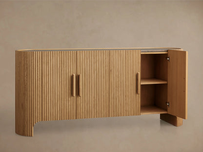 Astor Sideboard made of oak veneers with solid wood reeding, inset marble top, and open cabinet showing shelves and a soft-close door.