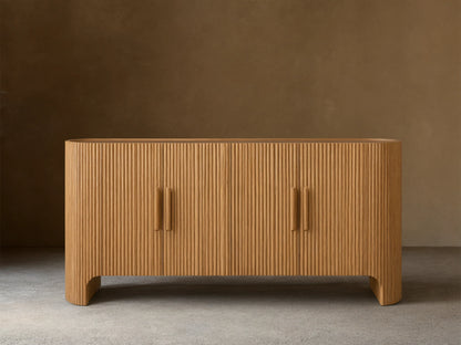 Astor Sideboard with vertical oak wood reeding, four soft-close doors, wooden pulls, and brass accents on a marble top.