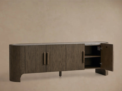 Astor Media Console with oak wood reeding, soft-close doors, and wooden pulls with brass accents. Inset marble top.