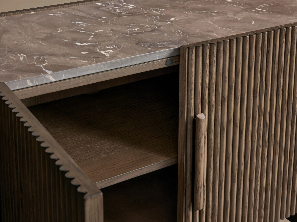 Astor Media Console with reeded oak wood detailing and natural marble top, features an open soft-close door revealing shelves inside.