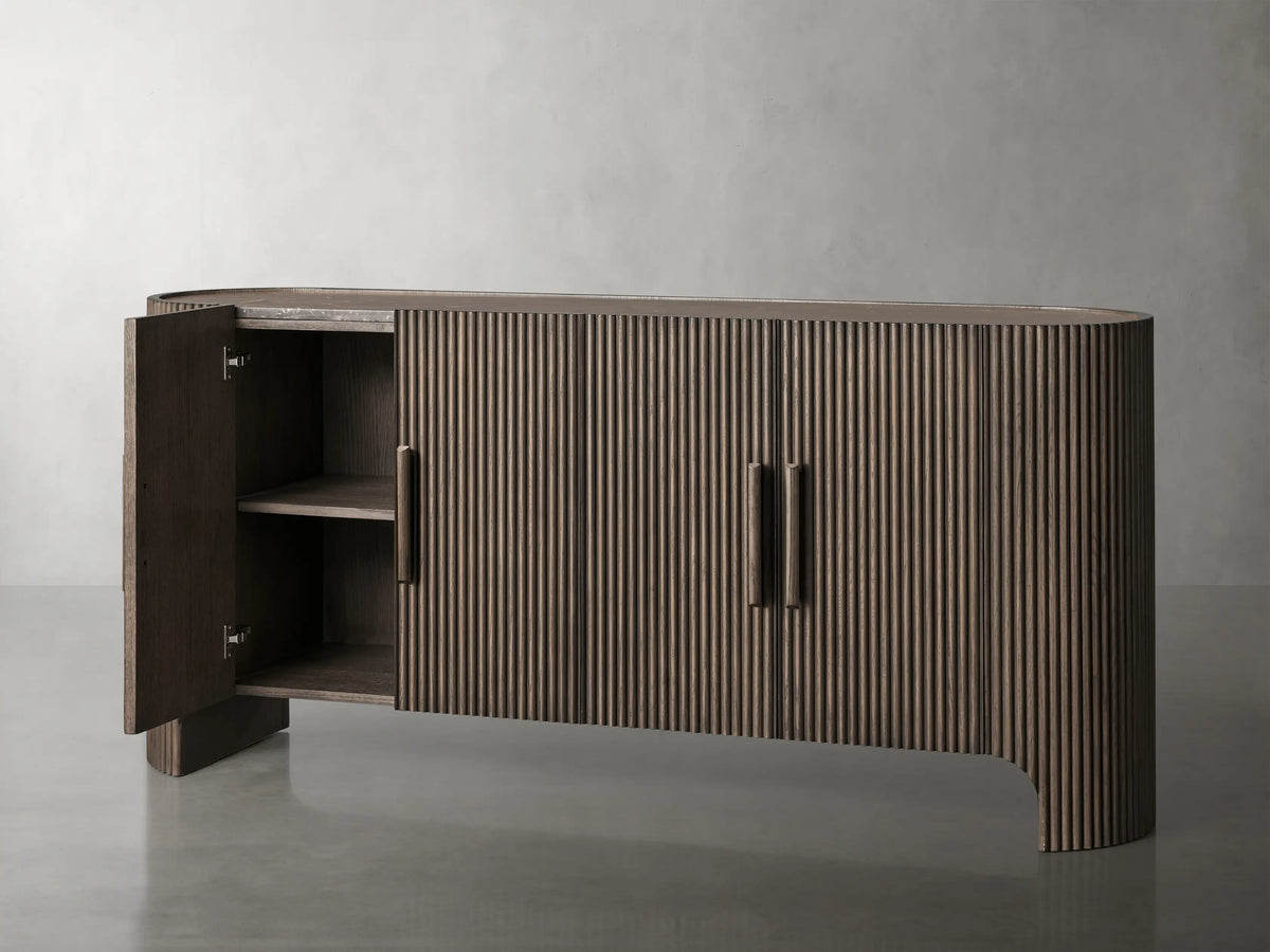 Astor Sideboard with vertically reeded solid oak wood finish, featuring soft-close doors and subtle brass-accented wooden pulls.