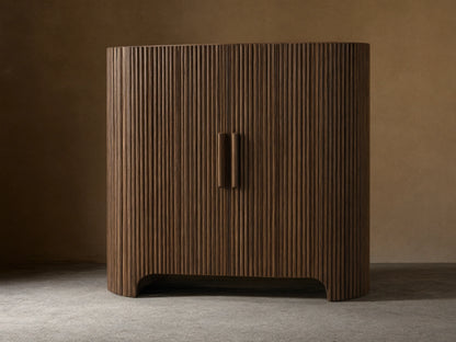 Astor Hall Chest: Dark brown, reeded oak veneer cabinet with curved sides, two doors, and wooden pulls on a wood floor.