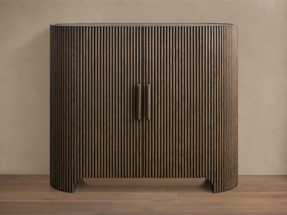 Astor Hall Chest with vertical oak wood reeding, two central soft-close doors, and inset marble top on wooden floor.