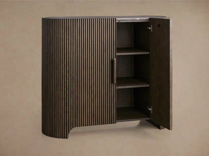 Astor Hall Chest made of oak veneers with vertical reeding, open wood cabinet door showing shelves, subtle brass accent.