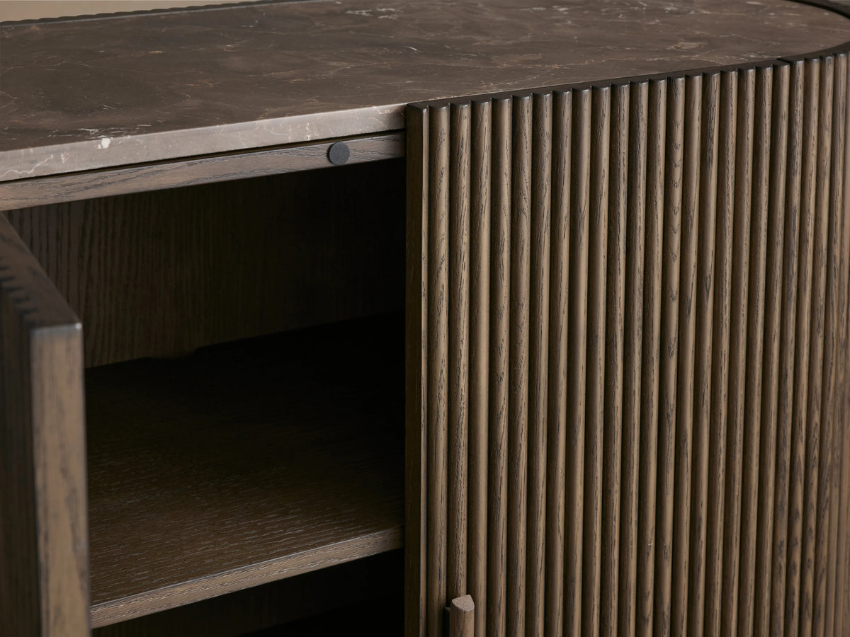 Astor Hall Chest with open soft-close door, showing oak wood reeding and natural marble top. Visible wooden pulls with brass accents.