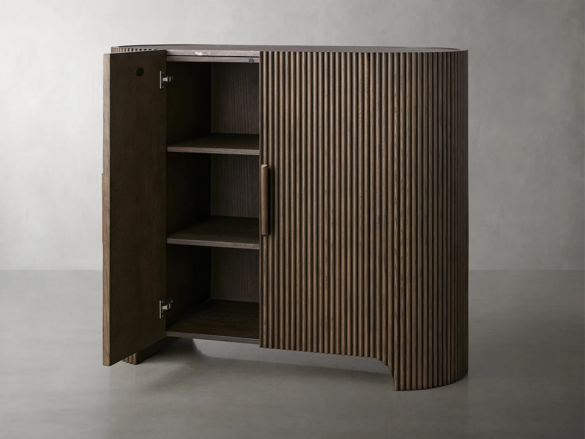 Astor Hall Chest with vertical oak veneer reeding and wooden pulls, featuring a natural marble top on a smooth surface.