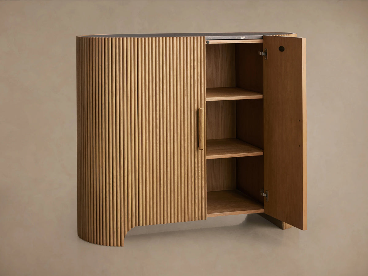 Astor Hall Chest made from oak with vertical reeding and wooden pulls. Inset marble top, brass or bronze accents, natural finish.