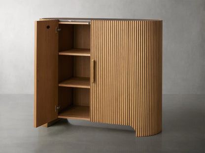 Astor Hall Chest with vertical oak wood reeding, soft-close doors, and wooden pulls on a gray background.
