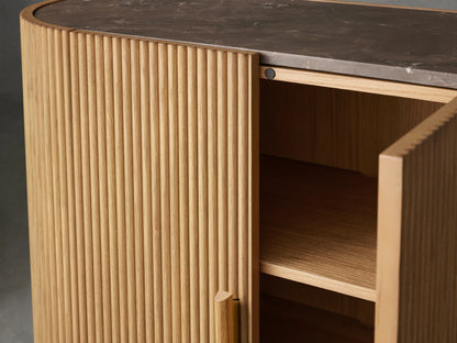 Astor Hall Chest featuring oak reeding details, open soft-close door showing shelves, with brass-accented wooden pull, and marble top.