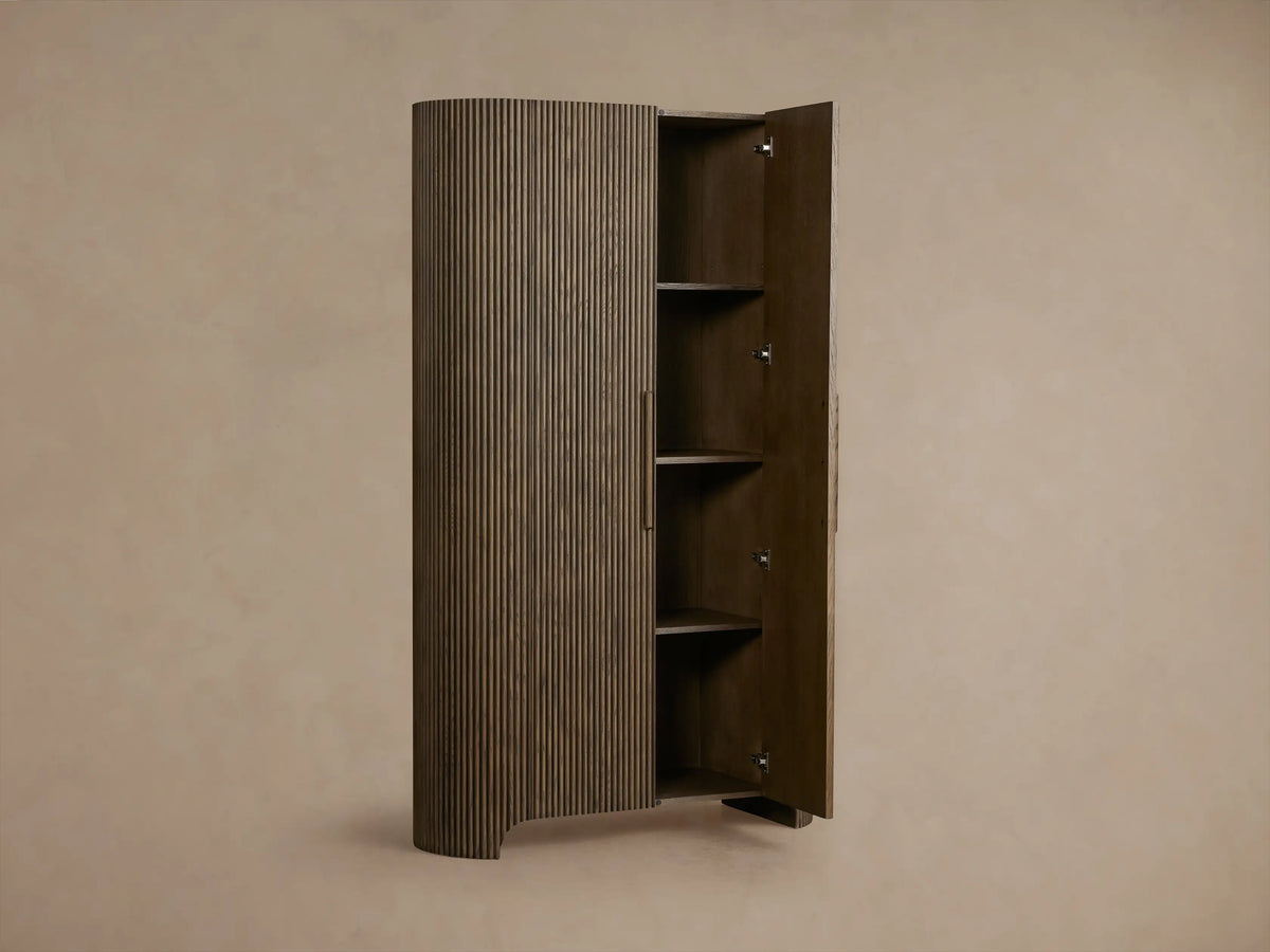 Front view of the dark oak Astor Cabinet with vertical reeding, rounded sides, and two vertical wooden pulls.