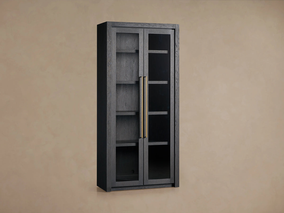 Bodhi Cabinet in dark oak finish with two glass panel doors, featuring solid brass handles and four adjustable interior shelves.