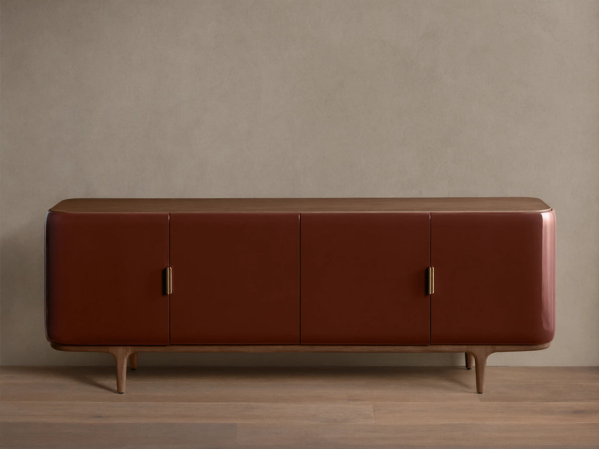 Front view of the Bryer Media Console, with oxblood lacquer finish, walnut top and base, and champagne brass handles.