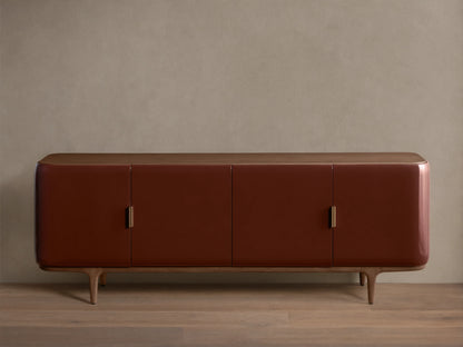 Front view of the Bryer Media Console, with oxblood lacquer finish, walnut top and base, and champagne brass handles.