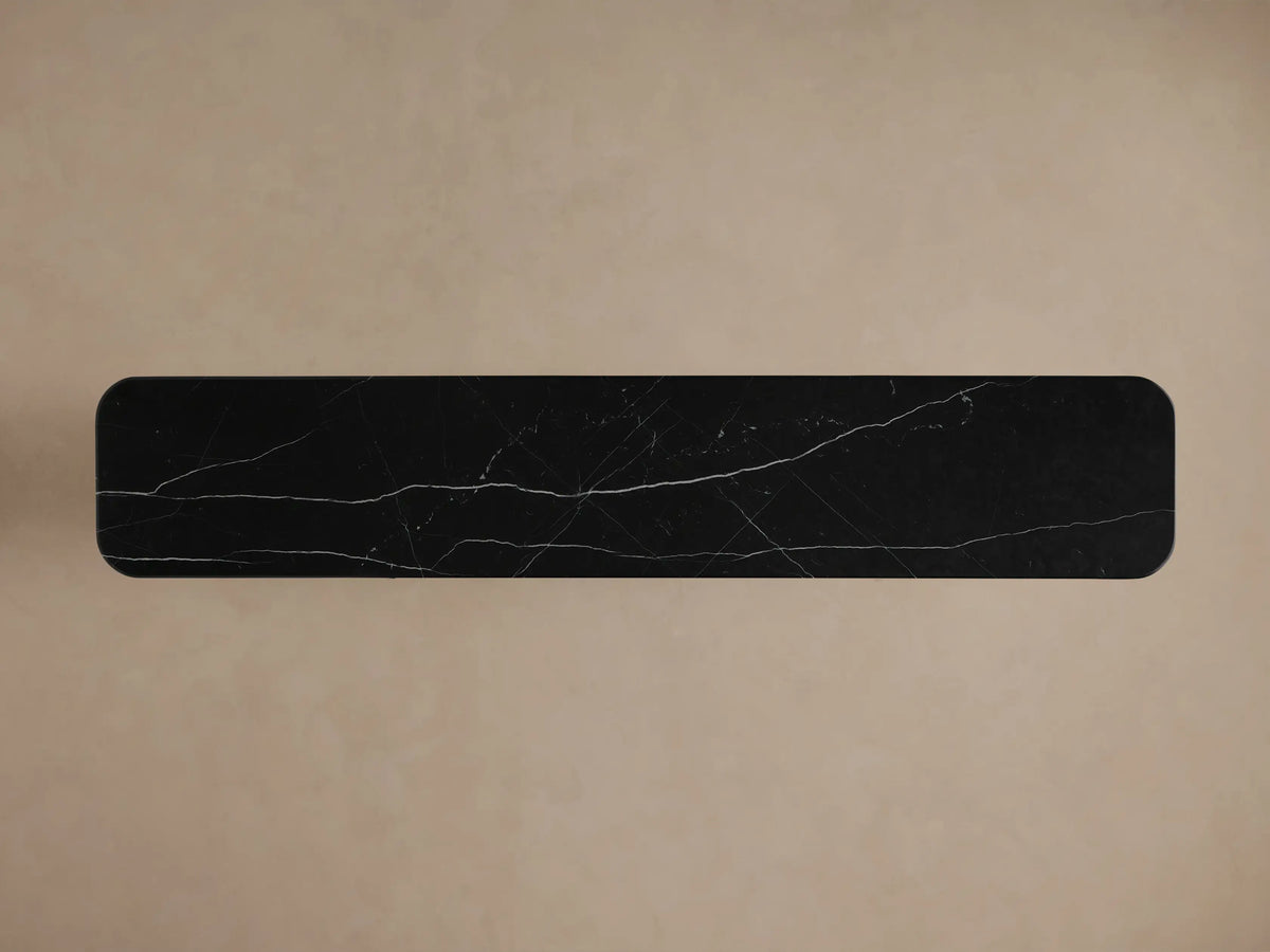 Caden Media Console close-up: dark walnut wood panel, black marble top, open section with books and decorative bowl.