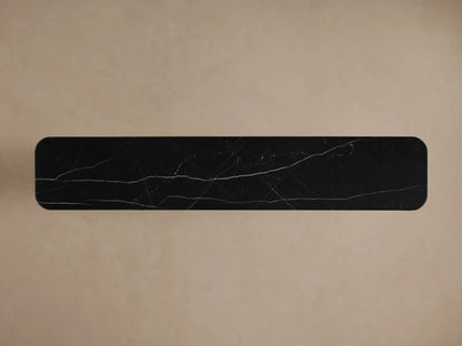 Caden Media Console close-up: dark walnut wood panel, black marble top, open section with books and decorative bowl.