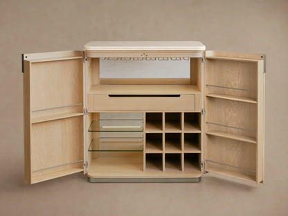 Caden Bar Cabinet in sand finish, open, revealing cream stone top, bottles, glassware, wine grid, and open drawer.