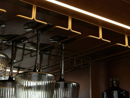 Caden Bar Cabinet with walnut wood veneer, rounded front, black marble top, and subtle vertical pull.