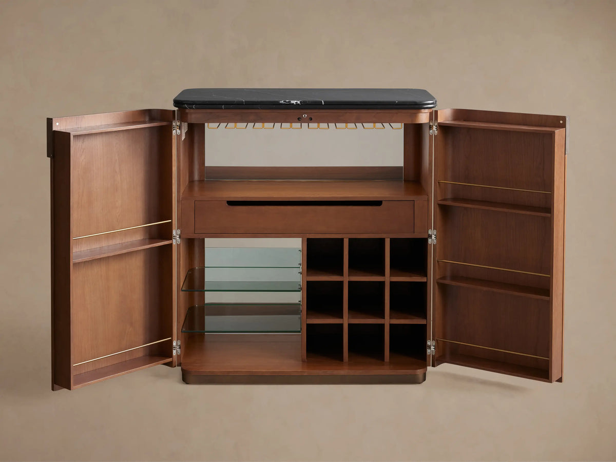 Open Caden Bar Cabinet, walnut wood with black top. Interior shows hanging stemware, wine bottles, glass shelves, and glasses.
