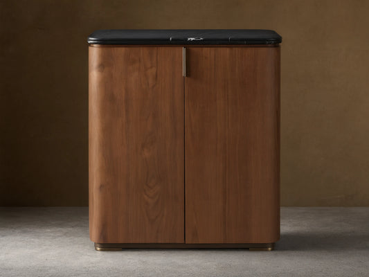 Caden Bar Cabinet with walnut wood veneer, rounded front, black marble top, and subtle vertical pull.