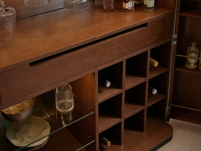 Open Caden Bar Cabinet, dark walnut with cream top, revealing stemware, bottles, wine grid, and glass shelves.